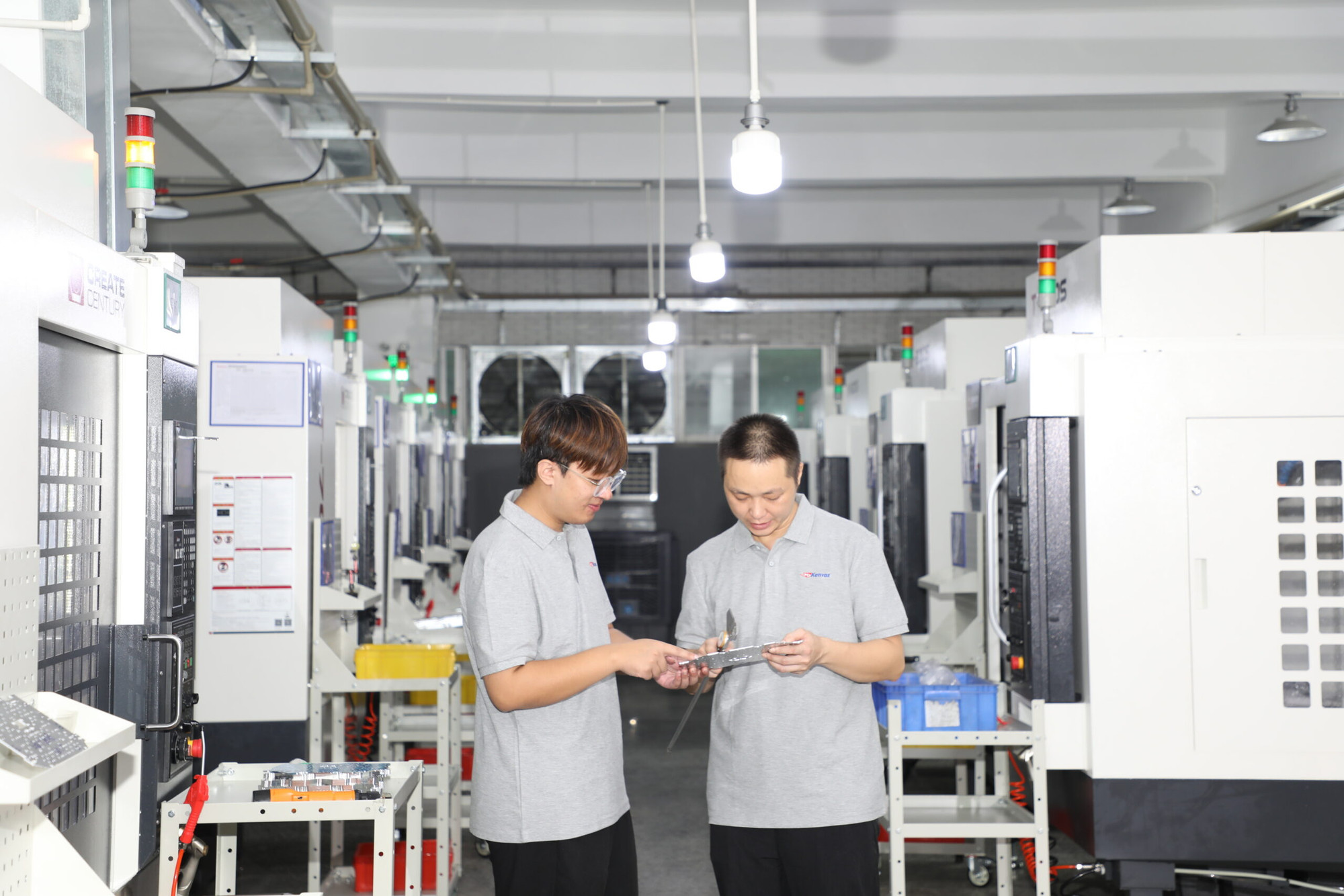 Kenvox manufacturing facility showing injection molding machines and ISO quality control team