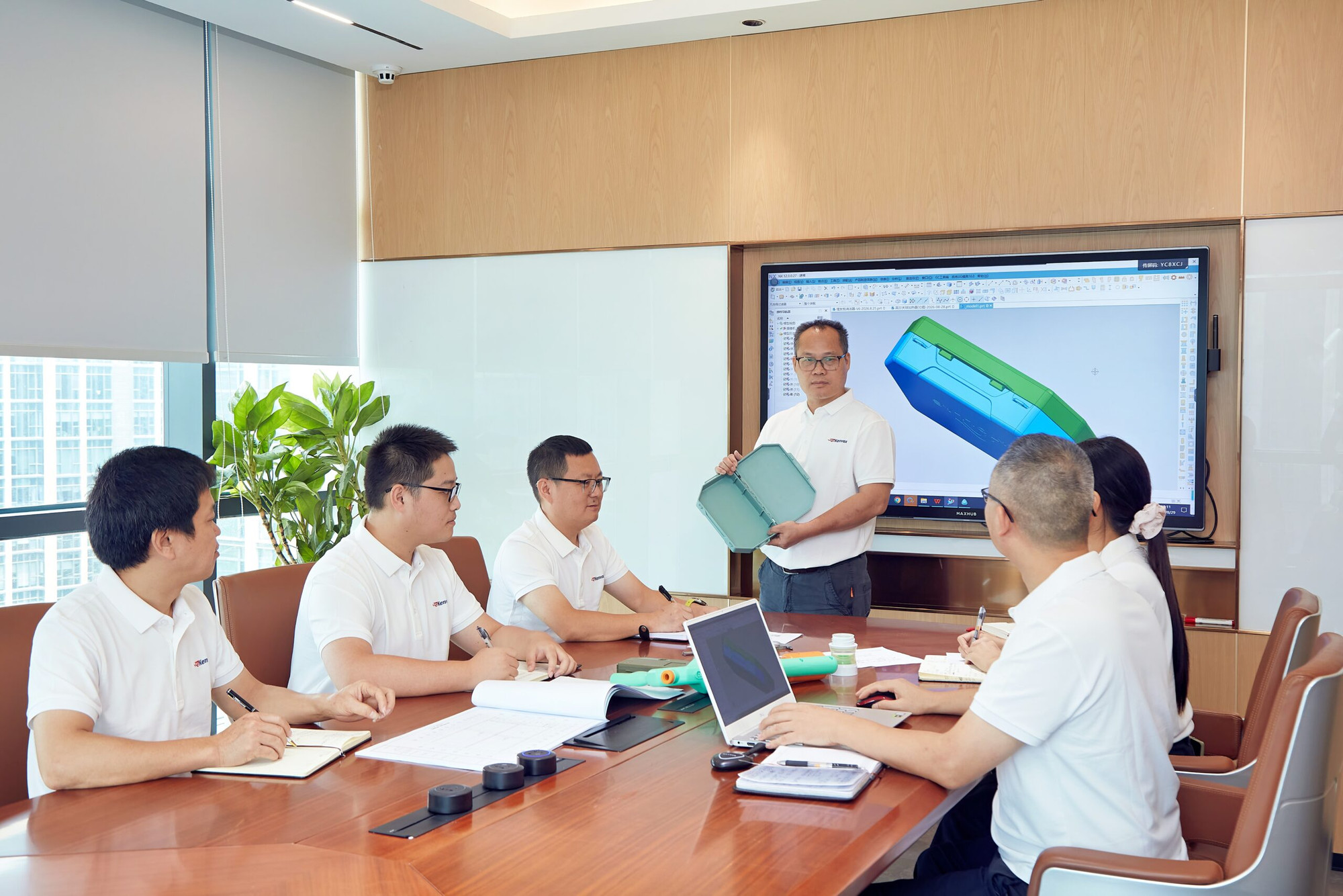 Kenvox engineering team reviewing 3D CAD design for product development